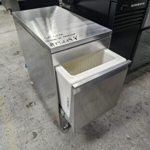 A stainless steel commercial freezer with an open white drawer, placed on a warehouse floor. “60 Litre Fridge or Freezer #R619P” is handwritten on the top surface. MRCE
